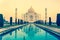 Taj Mahal monument reflecting in water of the pool in Agra India.