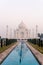 Taj Mahal monument with reflecting in water with tourist visiting in India.