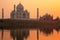 Taj Mahal reflected in Yamuna river at sunset in Agra, India