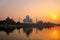 Taj Mahal reflected in Yamuna river at sunset in Agra, India