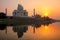 Taj Mahal reflected in Yamuna river at sunset in Agra, India