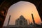 Taj Mahal at sunrise framed with the arch of the mosque, Agra, U