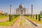 Taj Mahal tomb with reflection in the water in Agra, Uttar Pradesh, India.