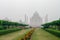 Taj Mahal view in morning fog from across the Mehtab Bagh or The