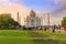 Taj Mahal white marble historic mausoleum at sunset with tourist enjoying the view at Agra India