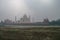 Taj Mahal and Yamuna river view in morning fog from Mehtab Bagh or The Moonlight Garden, Agra