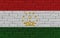 Tajikistan flag on brick wall 3d rendering