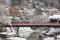 TAKAYAMA , JAPAN - January 29, 2019 : Nakabashi Bridge with snow fall and Miyakawa river and tourist in winter season . Landmark