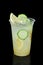 Take away glass with lemon and cucumber lemonade isolated on black