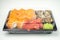 Take away sushi in plastic containers, philadelphia rolls and unagi maki, soy sauce, pink ginger, wasabi, sushi delivery concept