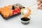 Take away sushi in plastic containers, philadelphia rolls and unagi maki, soy sauce, pink ginger, wasabi, sushi delivery concept