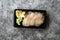 Take Away Suzuki Fish Sashimi with Pickled Ginger and Wasabi in Black Plastic Plate Container / Package. Traditional Fast Food