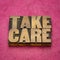 Take care word abstract in vintage letterpress wood type