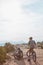 Take a little breather. Full length shot of two athletic men taking a break while mountain biking through the wilderness