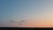 Take off the plane in the distance against the background of sunrise or sunset. Silhouette of an airplane. Airplane in