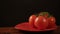 Take one ripe tomato from a red plate, and then put back