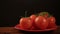 Take one ripe tomato from a red plate, and then put back