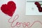 Take a red yarn into heart shape and wording love with red roses