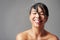 Take a shower and feel reinvigorated. Studio shot of a young woman enjoying a shower against a gray background.