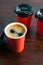 Takeaway coffee in paper cups on a wooden table. The concept of cafes and restaurants during the covid 19 quarantine period, lunch