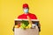 Takeaway delivery, covid-19 quarantine and groceries concept. Cheerful smiling courier in red uniform and medical mask