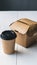 Takeaway duo Kraft paper box with hinged lid and cylindrical cup with black lid