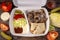 Takeaway fast food in lunch box - fresh vegetables, pita bread and pork