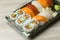 Takeaway food plastic containers for Sushi, Sashimi and Futomaki rolls. Fresh made Sushi set with salmon, prawns, wasabi and ging