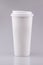 Takeaway white coffee cup with blank area on grey background