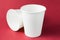 Takeaway white coffee drinking paper cup for hot tea, coffee and juice isolated  on red background, mockup