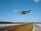 Takeoff of an old biplane plane from a winter airfield from a runway with grass with a blue sky background