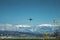 Takeoff of a passenger airplane against the backdrop of high scenic mountains