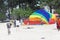 Takes off the parachutein in the blue sky tropical beach. Two Chinese tourists flying on a parachute over the sea on a beach in Ph