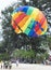 Takes off the parachutein in the blue sky tropical beach. Two Chinese tourists flying on a parachute over the sea on a beach in Ph