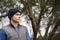 Taking a breath of fresh air. A young male standing in a forest with a contemplative look on his face.