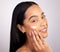 Taking care of your skin doesnt have to be a chore. Studio portrait of an attractive young woman applying moisturizer to