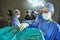 Taking charge of a surgical procedure. surgeons in an operating room.