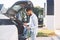 Taking charging wire from the truck. Young stylish man is with electric car at daytime