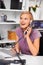 Taking a guess at the answer. a beautiful young woman using a phone at her desk.