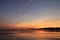 Taking photos of scenic view just before sunrise of silhouette deux jumeaux in colorful summer sky on a sandy beach