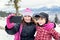 Taking selfie! Family. Happy mother and little boy making self portrait in the winter mountains.