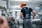 Taking the window. Industrial worker indoors in factory. Young technician with orange hard hat