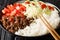 Takoraisu Taco rice is a Japanese dish hailing from Okinawa close-up in a bowl. Horizontal