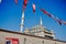 Taksim square covered by many Turkish flag and taksim mosque almost finished. Ataturk