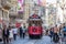 Taksim Tunel Nostalgia Tram trundles along the istiklal street and people at istiklal avenue. Istanbul, Turkey