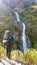 Tal - A man admiring a waterfall in Himalayas