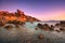 Talamone rock beach and medieval fortress at sunset. Maremma Argentario, Tuscany, Italy