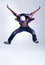 Talent, jump and child hip hop dancer dancing isolated in a white studio background in a pose feeling excited. Dance