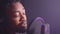 talented african american singer is singing new song in audio record studio, closeup portrait