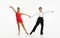 Talented, beautiful, artistic children, boy and girl in stage costumes dancing retro style dance against white studio
